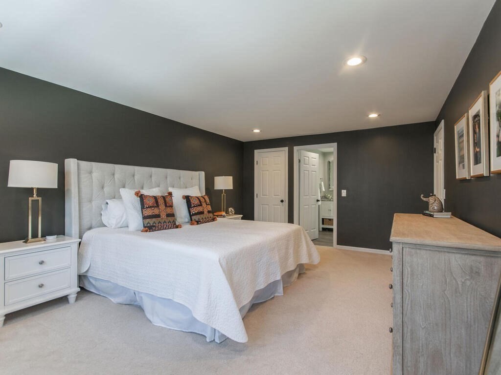 19 Quinnehtuk Road Longmeadow, MA 01106 - Photo 25 of 42 a spacious bedroom with a bed and a flat tv screen on dresser