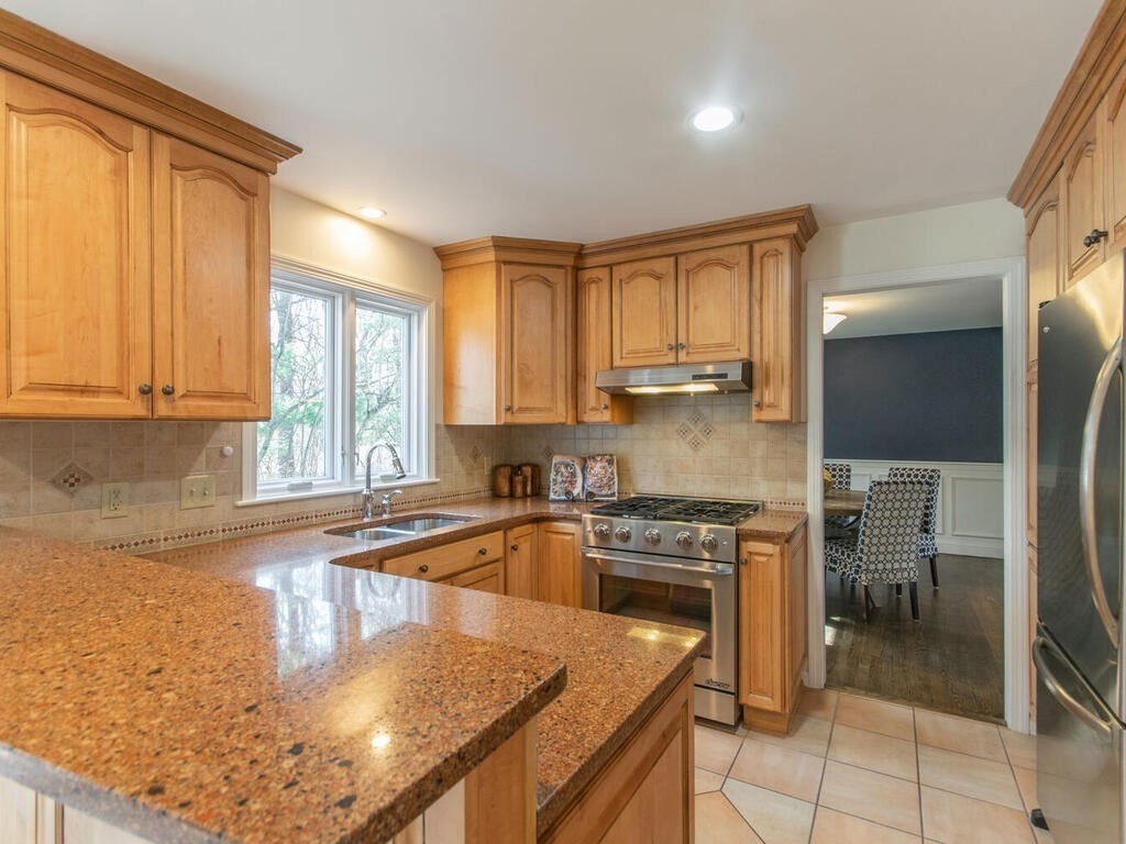 19 Quinnehtuk Road Longmeadow, MA 01106 - Photo 9 of 42 a kitchen with a stove a sink and a refrigerator