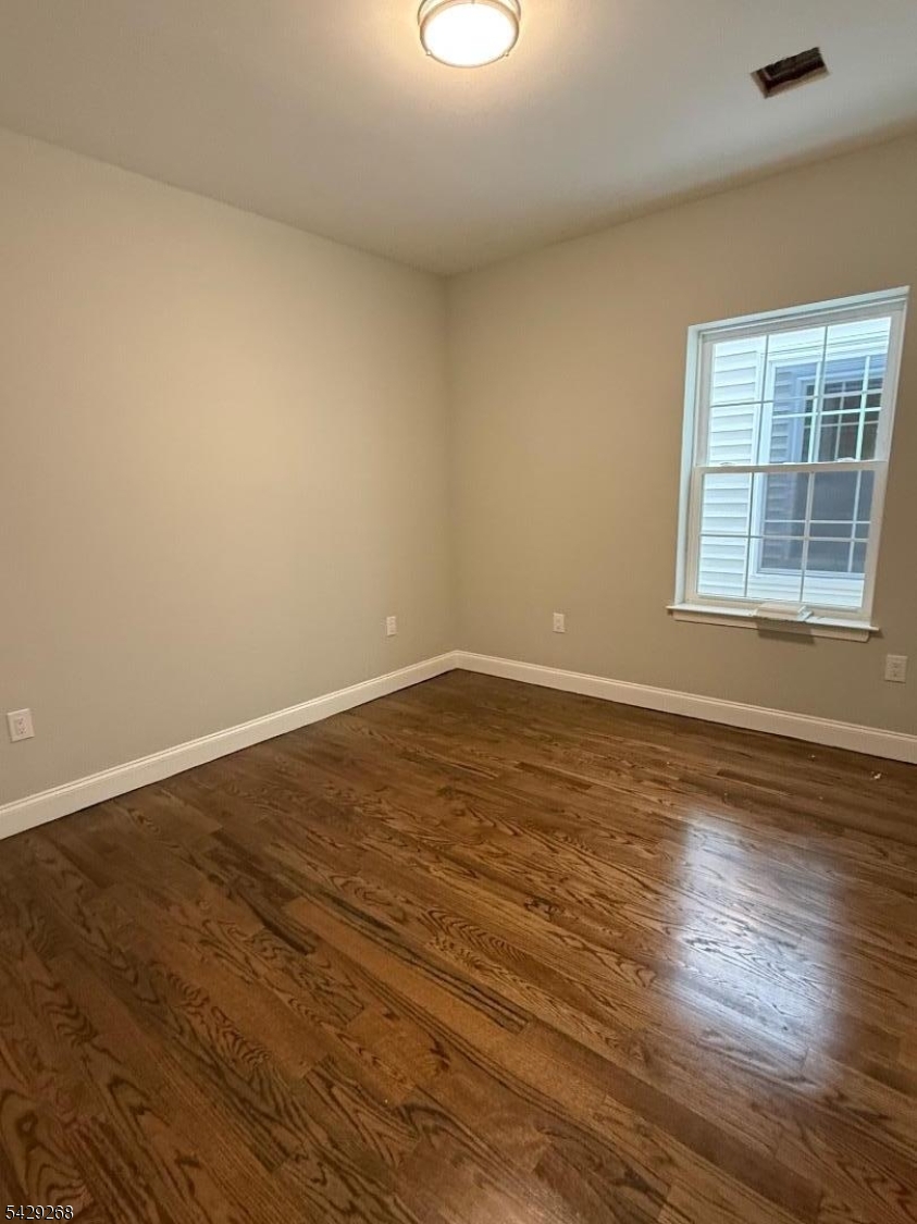 223 South 11th Street, Unit 2 Newark, NJ 07107 - Photo 6 of 15 wooden floor in an empty room with a window