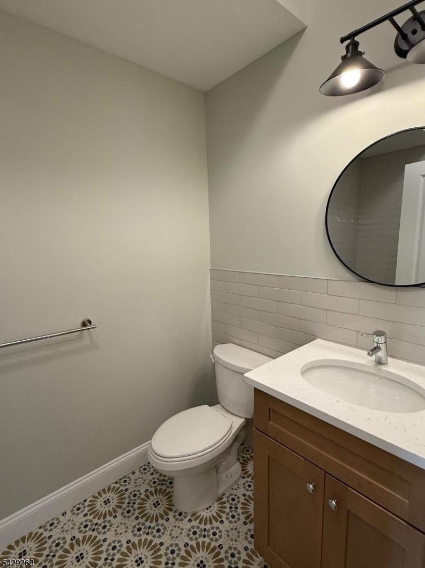 223 South 11th Street, Unit 2 Newark, NJ 07107 - Photo 8 of 15 a bathroom with a toilet a sink and mirror
