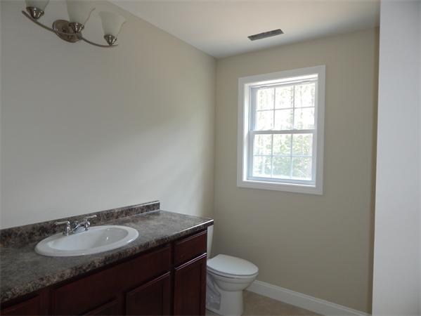 1328 Mammoth Road Pelham, NH 03076 - Photo 15 of 16 a bathroom with a granite countertop sink toilet and mirror