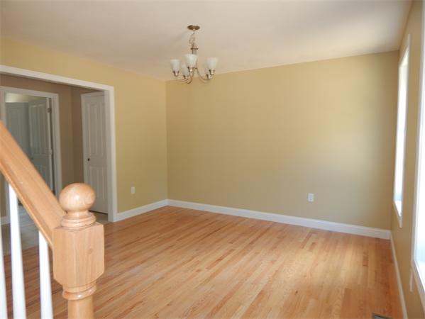 1328 Mammoth Road Pelham, NH 03076 - Photo 6 of 16 a view of empty room with wooden floor