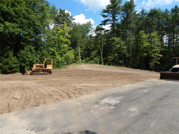1328 Mammoth Road Pelham, NH 03076 - Photo 8 of 16 a view of a ocean with a bench and trees around