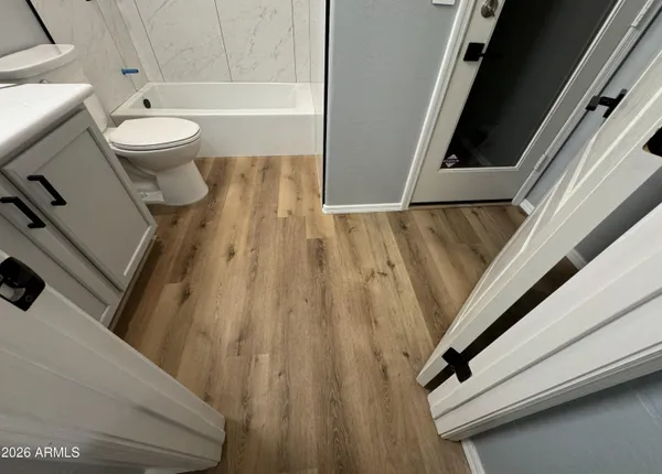 a bathroom with a toilet and a shower