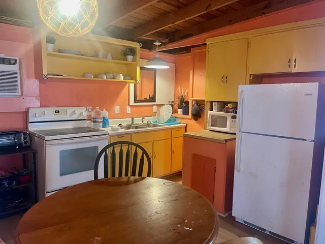 a kitchen with a sink a stove and refrigerator