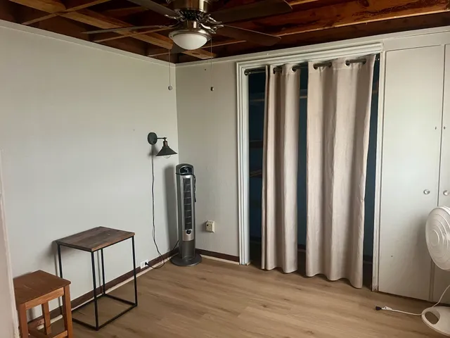 a view of a hallway with wooden floor and stairs