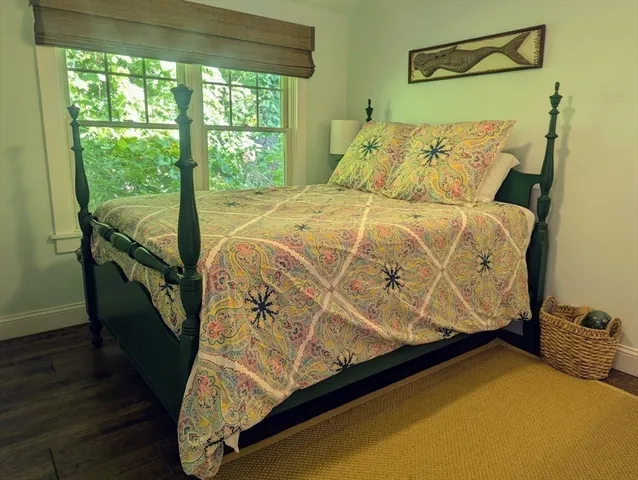 a bed sitting in a bedroom next to a window