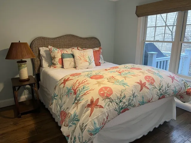 a large bed sitting in a bedroom next to a window