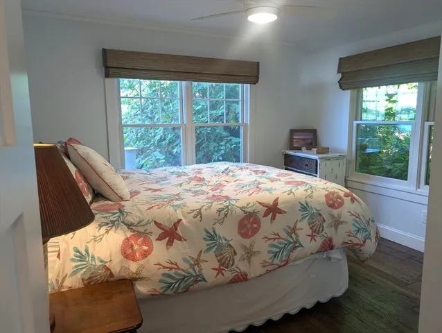 a bed sitting in a bedroom next to a window