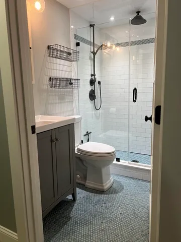 a bathroom with a sink a toilet and shower