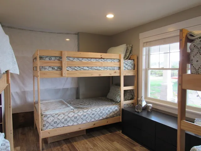 a room with pool table and windows