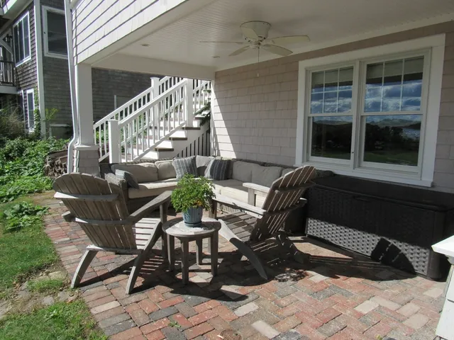 a view of a house with backyard and sitting area