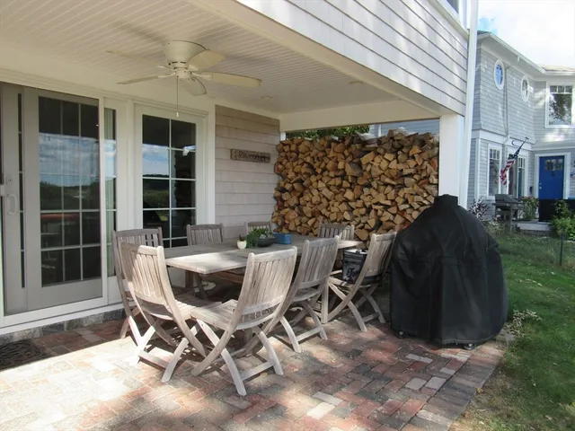 a view of a patio with table and chairs and potted plants