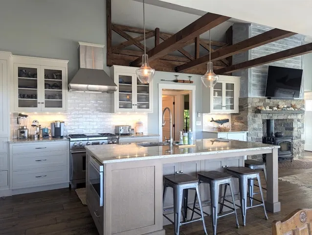 a kitchen with stainless steel appliances granite countertop a stove and cabinets