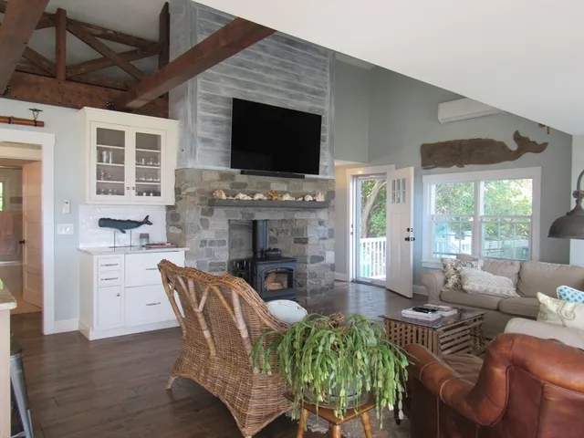 a living room with fireplace furniture and a flat screen tv
