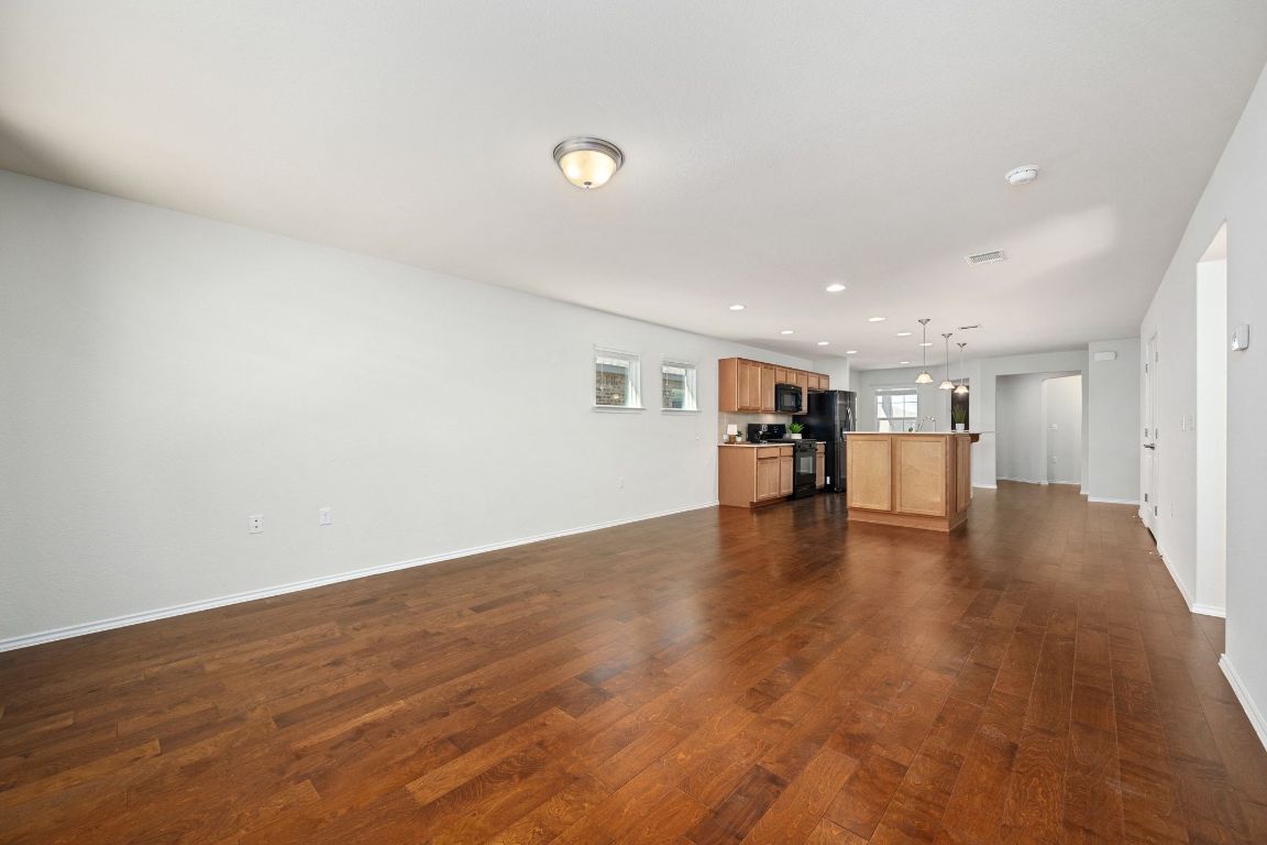 225 Hobby Street Georgetown, TX 78633 - Photo 13 of 40 a view of empty room with wooden floor