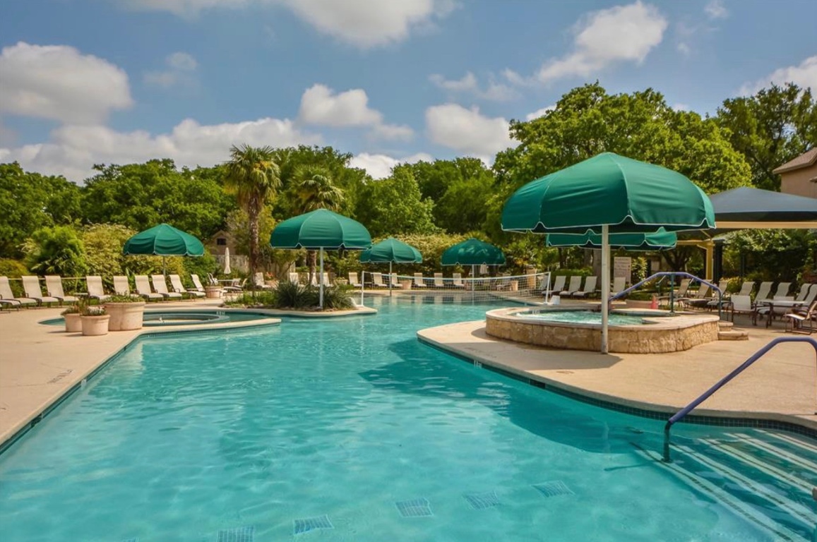 225 Hobby Street Georgetown, TX 78633 - Photo 31 of 40 a view of a swimming pool with lawn chairs under an umbrella