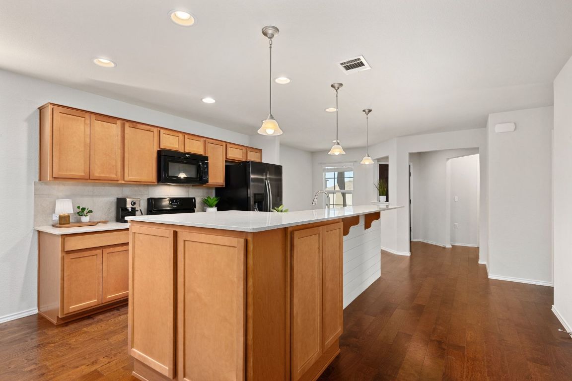 225 Hobby Street Georgetown, TX 78633 - Photo 8 of 40 a large kitchen with stainless steel appliances lots of counter space