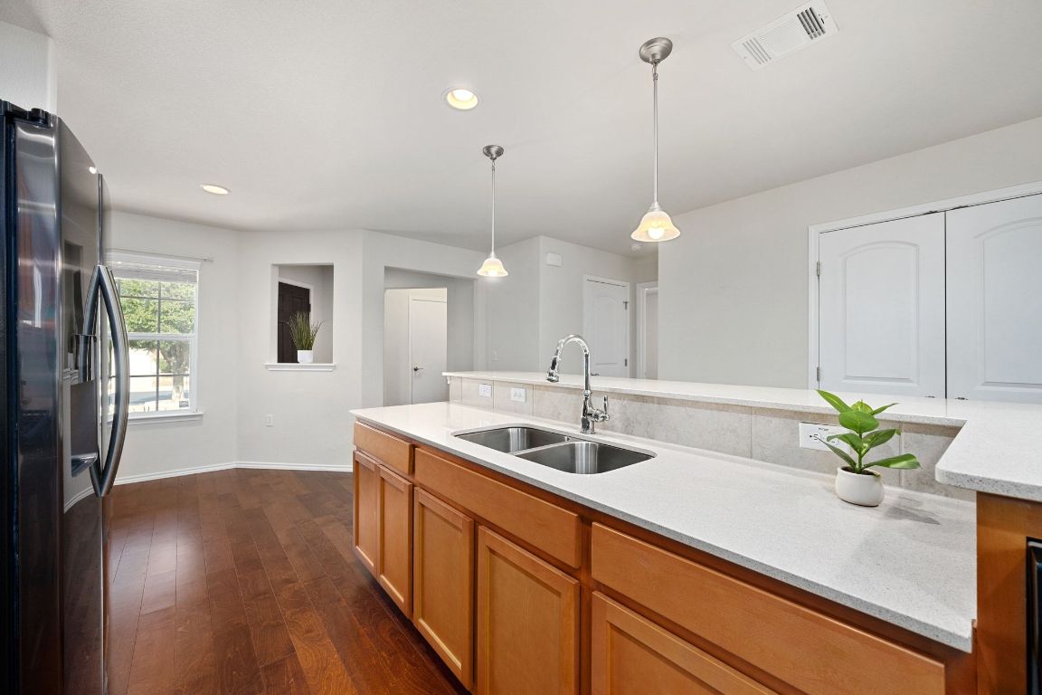 225 Hobby Street Georgetown, TX 78633 - Photo 10 of 40 a kitchen with a sink and chandelier