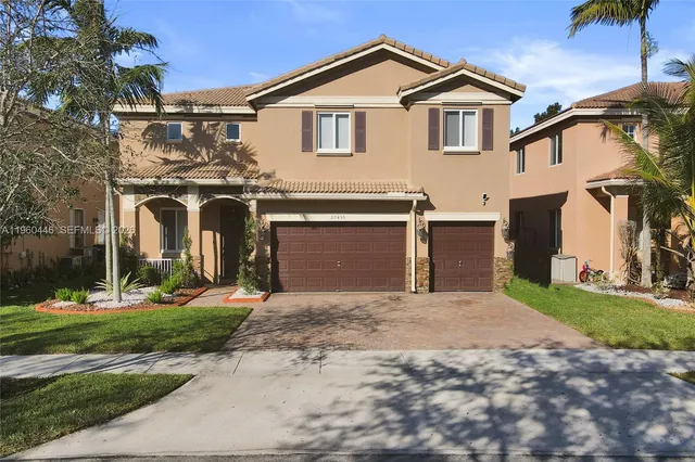 a front view of a house with a yard and garage