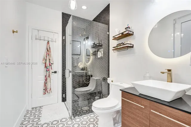 a bed sitting in a bedroom next to a window with a chandelier