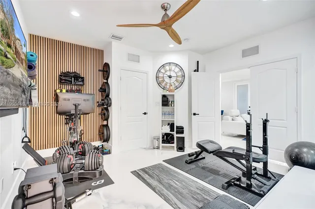 a view of a yard in front of a brick house with a large tree