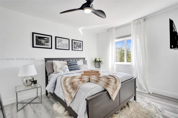 a bedroom with a bed and wooden floor