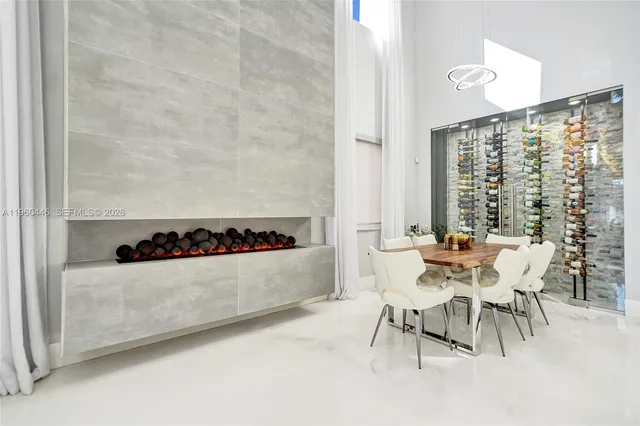 a kitchen with stainless steel appliances a stove top oven a refrigerator a sink and white cabinets