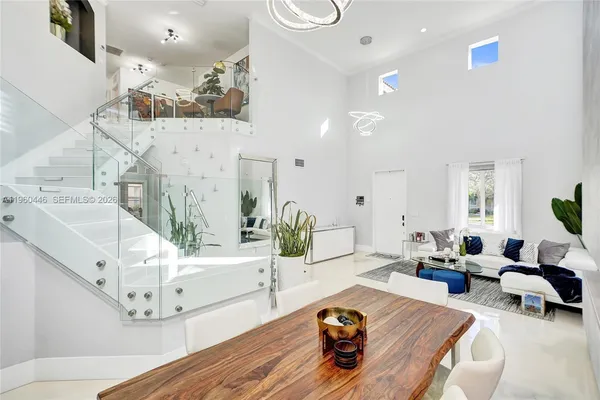 a living room with furniture flat screen tv and a large window