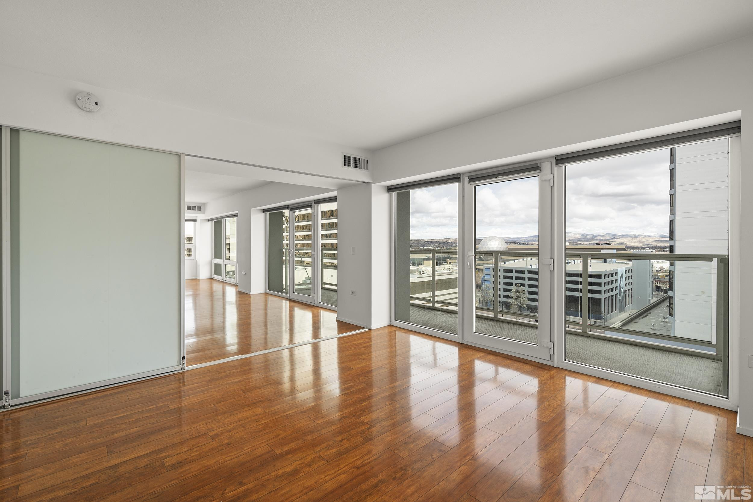 255 North Sierra Street, Unit 1011 Reno, NV 89501 - Photo 15 of 40 a view of an empty room with wooden floor and a window