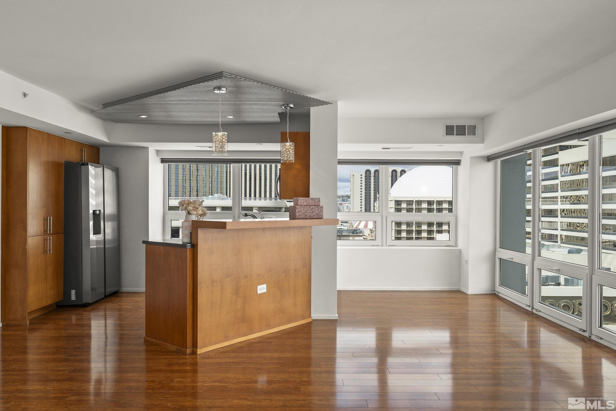 255 North Sierra Street, Unit 1011 Reno, NV 89501 - Photo 16 of 40 a room with kitchen island a counter top space a sink and a refrigerator