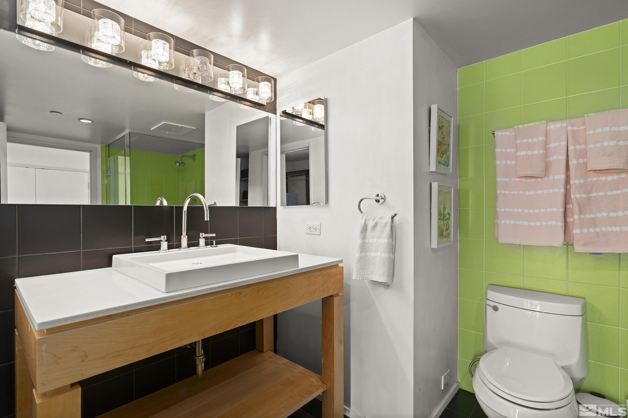 255 North Sierra Street, Unit 1011 Reno, NV 89501 - Photo 20 of 40 a bathroom with a sink a toilet a mirror and shower