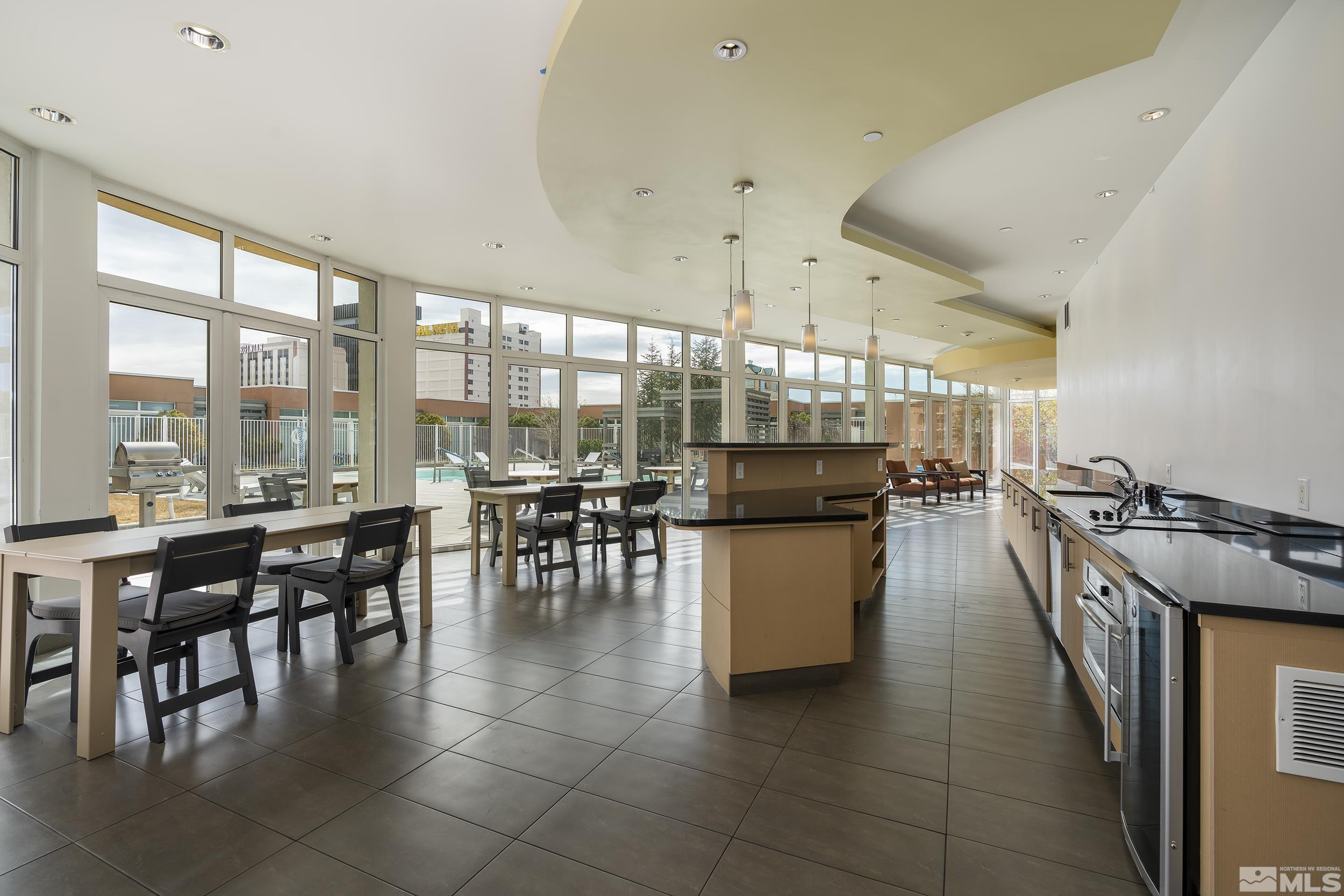 255 North Sierra Street, Unit 1011 Reno, NV 89501 - Photo 35 of 40 a dining hall with stainless steel appliances a dining table and chairs