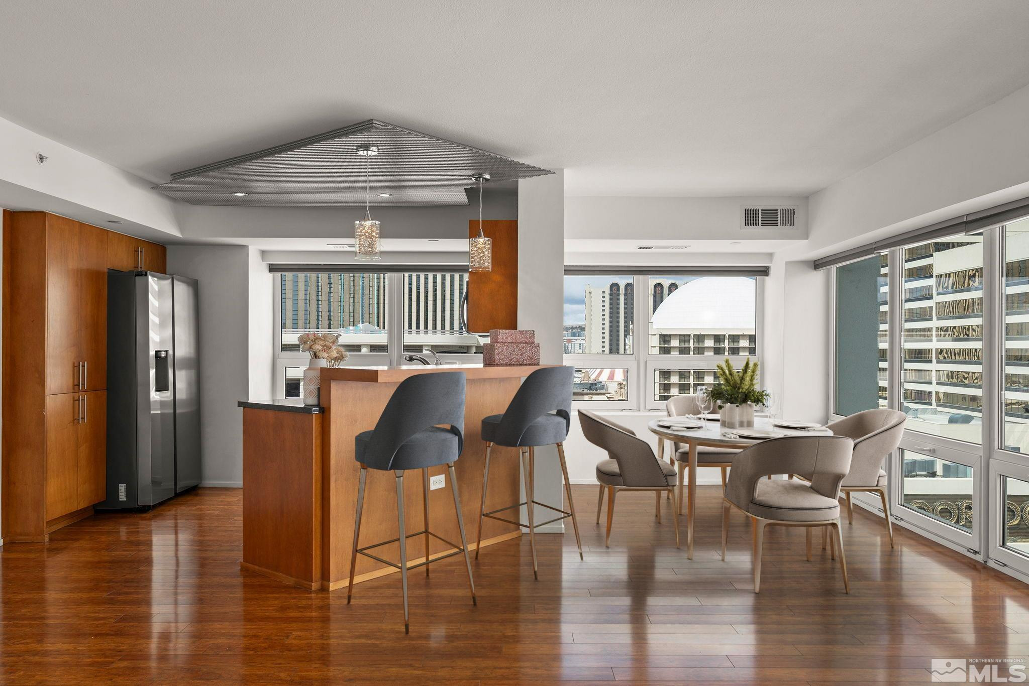 255 North Sierra Street, Unit 1011 Reno, NV 89501 - Photo 4 of 40 a dining room with furniture window wooden floor and outside view