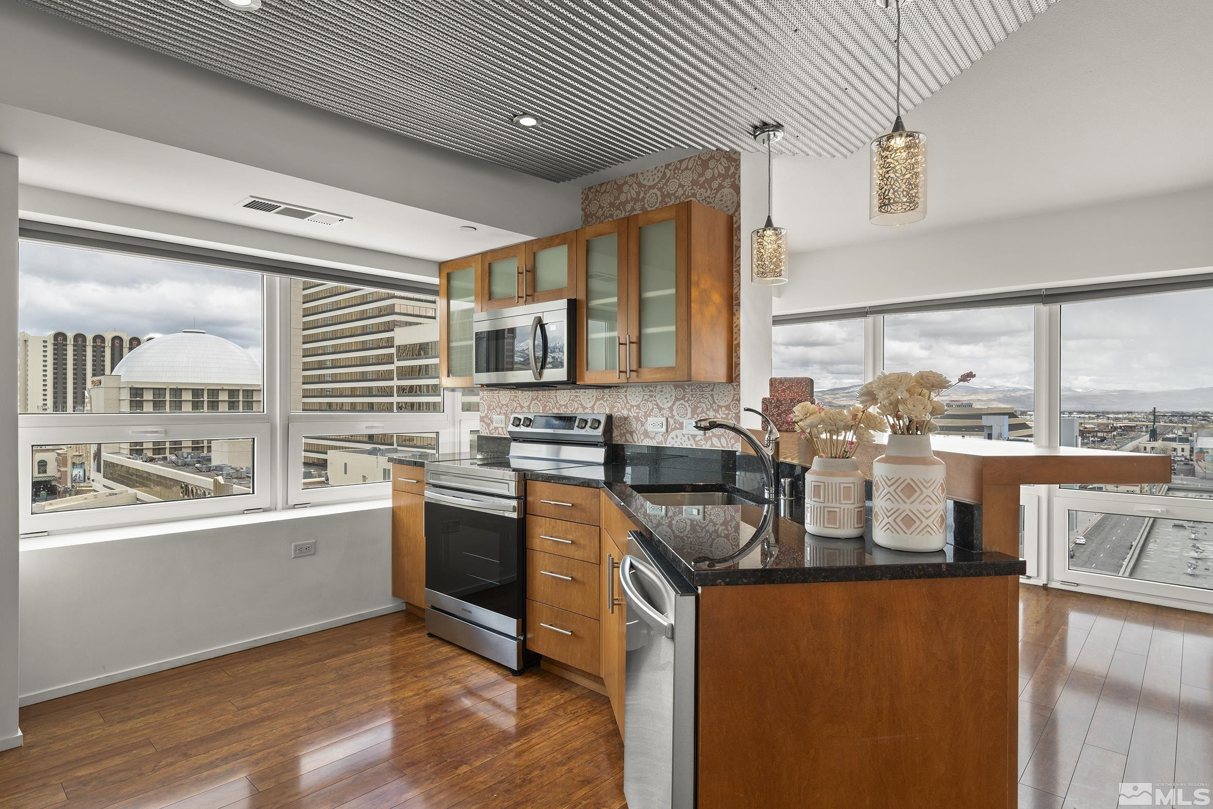 255 North Sierra Street, Unit 1011 Reno, NV 89501 - Photo 8 of 40 a kitchen with stainless steel appliances granite countertop a sink a stove and a refrigerator