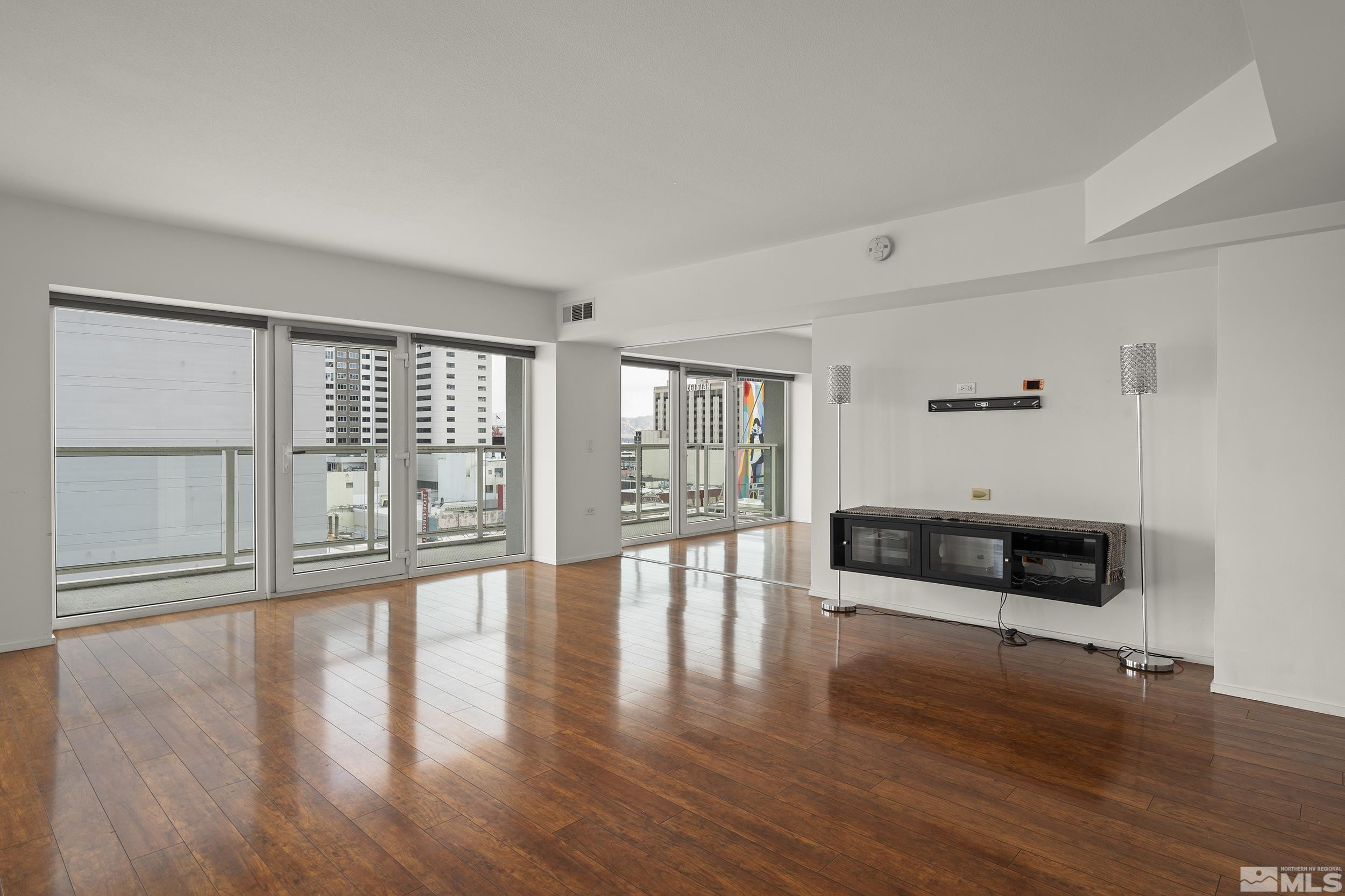 255 North Sierra Street, Unit 1011 Reno, NV 89501 - Photo 10 of 40 a view of an empty room with wooden floor and a window