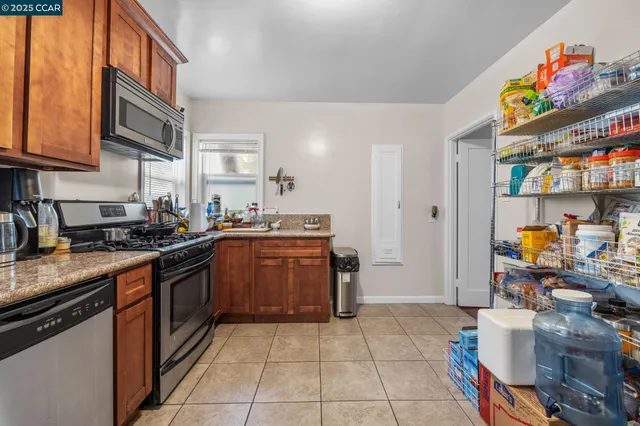 a kitchen with stainless steel appliances granite countertop a sink and cabinets