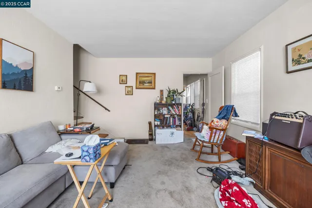 a living room with furniture a rug and a painting on the wall