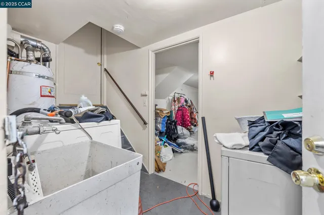 a utility room with sink dryer and bicycles