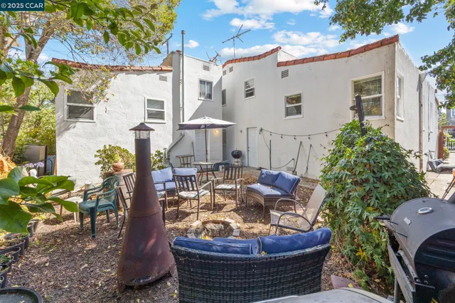a view of a patio with table and chairs potted plants
