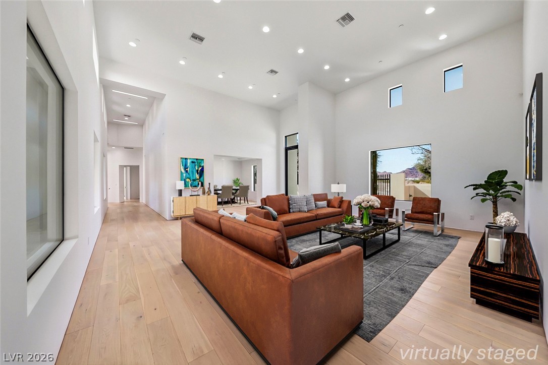 1140 Julie Road Henderson, NV 89002 - Photo 7 of 85 Lofty ceilings and well-lit interiors define this spacious living room, offering a bright and inviting atmosphere.1140 JULIE Rd Henderson NV 89002 Virtually staged