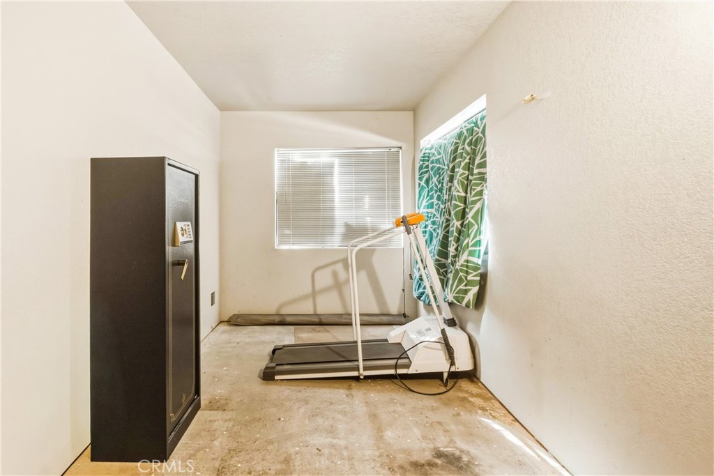 5975 Desert Star Road Johnson Valley, CA 92285 - Photo 23 of 74 a room with gym equipment and a large window