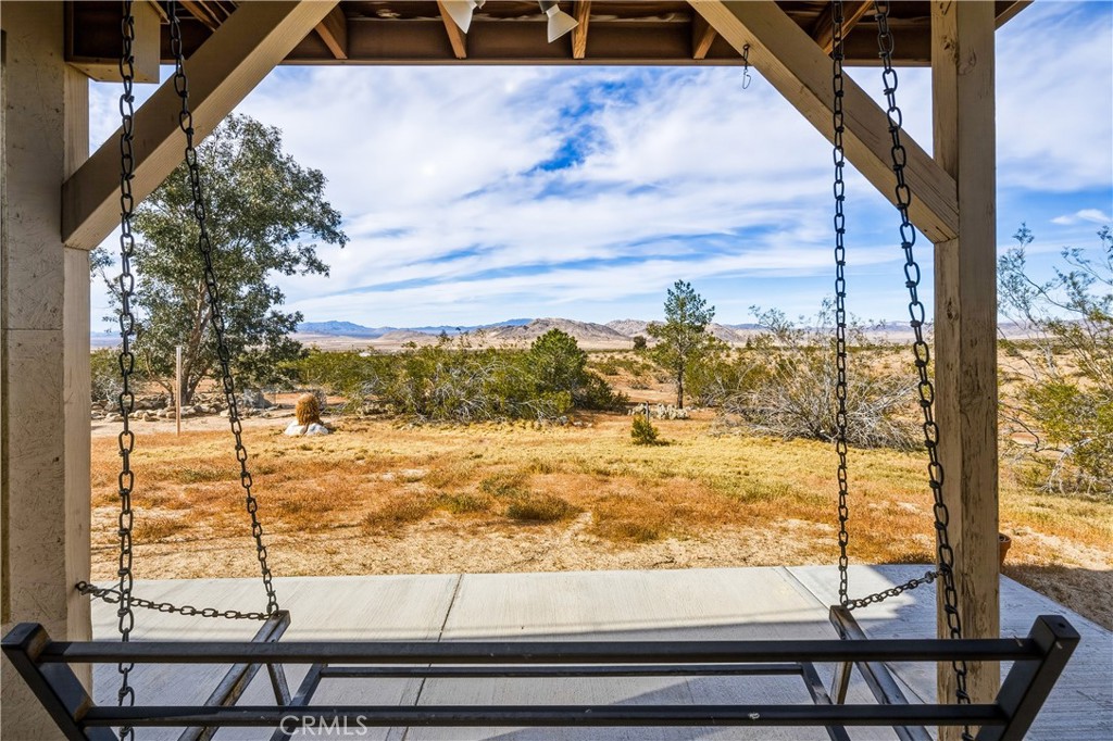 5975 Desert Star Road Johnson Valley, CA 92285 - Photo 24 of 74 a view of a balcony with a floor to ceiling window and wooden floor