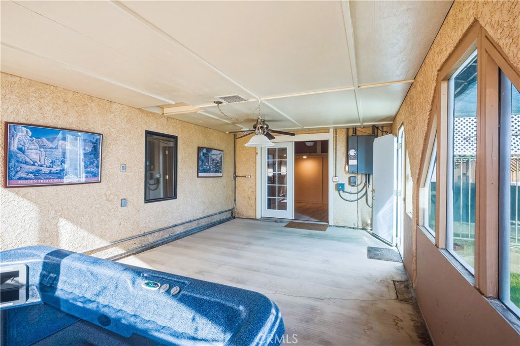 5975 Desert Star Road Johnson Valley, CA 92285 - Photo 28 of 74 a spacious bedroom with a large bed and a chandelier