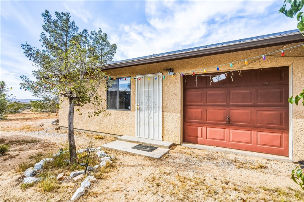 5975 Desert Star Road Johnson Valley, CA 92285 - Photo 29 of 74 a view of a house with a wooden fence