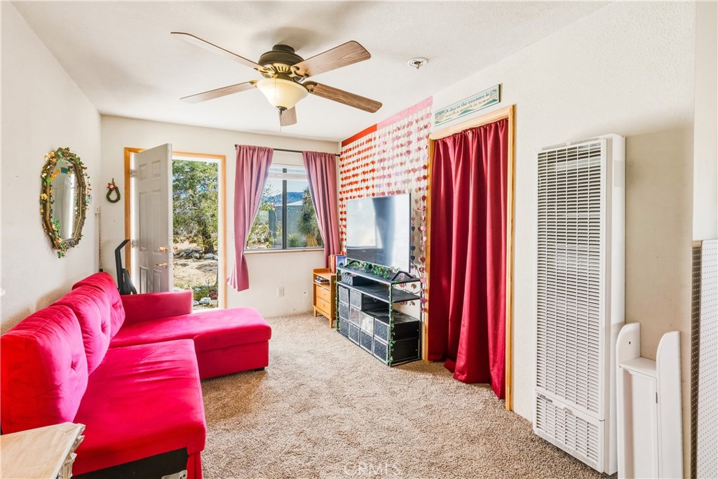 5975 Desert Star Road Johnson Valley, CA 92285 - Photo 32 of 74 a living room with furniture and a flat screen tv