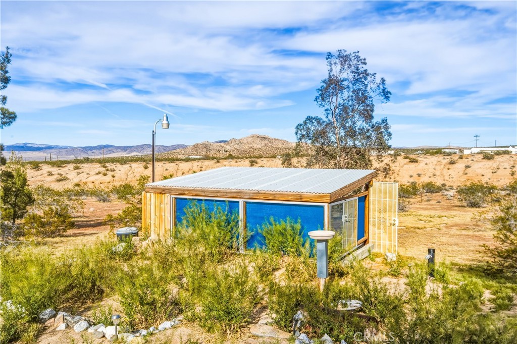 5975 Desert Star Road Johnson Valley, CA 92285 - Photo 38 of 74 a view of a house with a yard