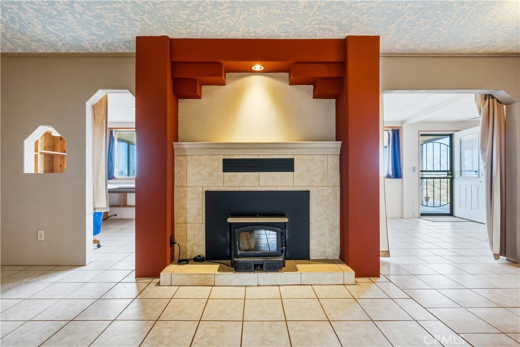 5975 Desert Star Road Johnson Valley, CA 92285 - Photo 4 of 74 a view of a livingroom with a fireplace and a chandelier