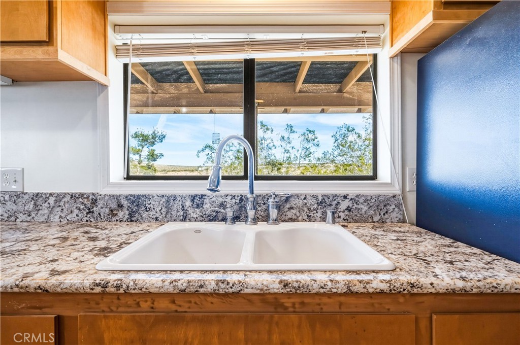 5975 Desert Star Road Johnson Valley, CA 92285 - Photo 5 of 74 a bathroom with a granite countertop sink and bathtub