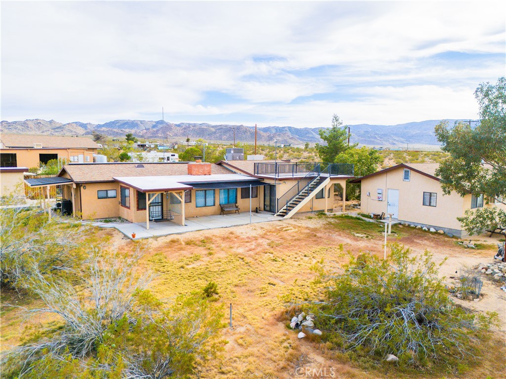 5975 Desert Star Road Johnson Valley, CA 92285 - Photo 57 of 74 a view of a house with a big yard and large trees